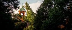 Montclair State University campus bell tower among green trees.